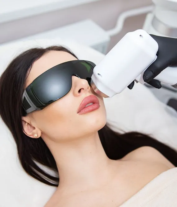 Q-switch laser toning handpiece on a woman's face